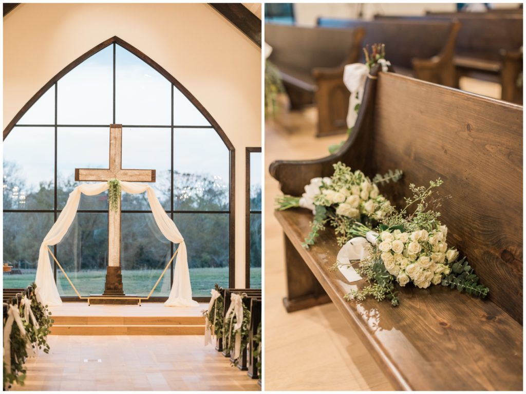The cross and pew seats with flowers at a barn wedding