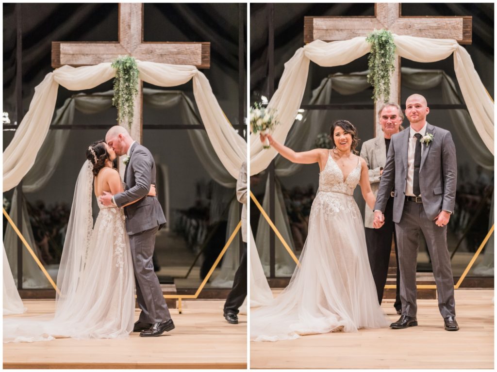 Barn wedding ceremony with a couple kissing under the cross