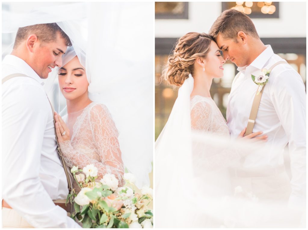 Couple poses intimately for their white barn wedding photos