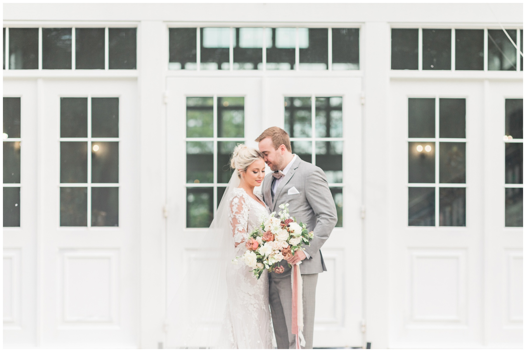 Bride in a lace gown with scalloped edges and long sleeves