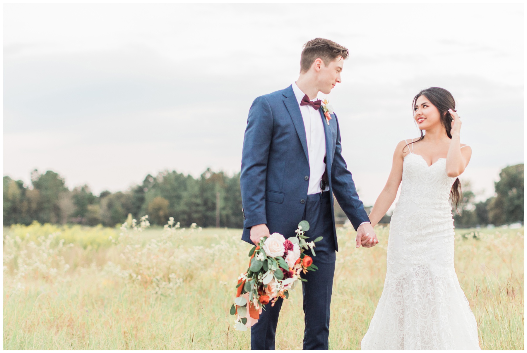 bride and groom portraits in field