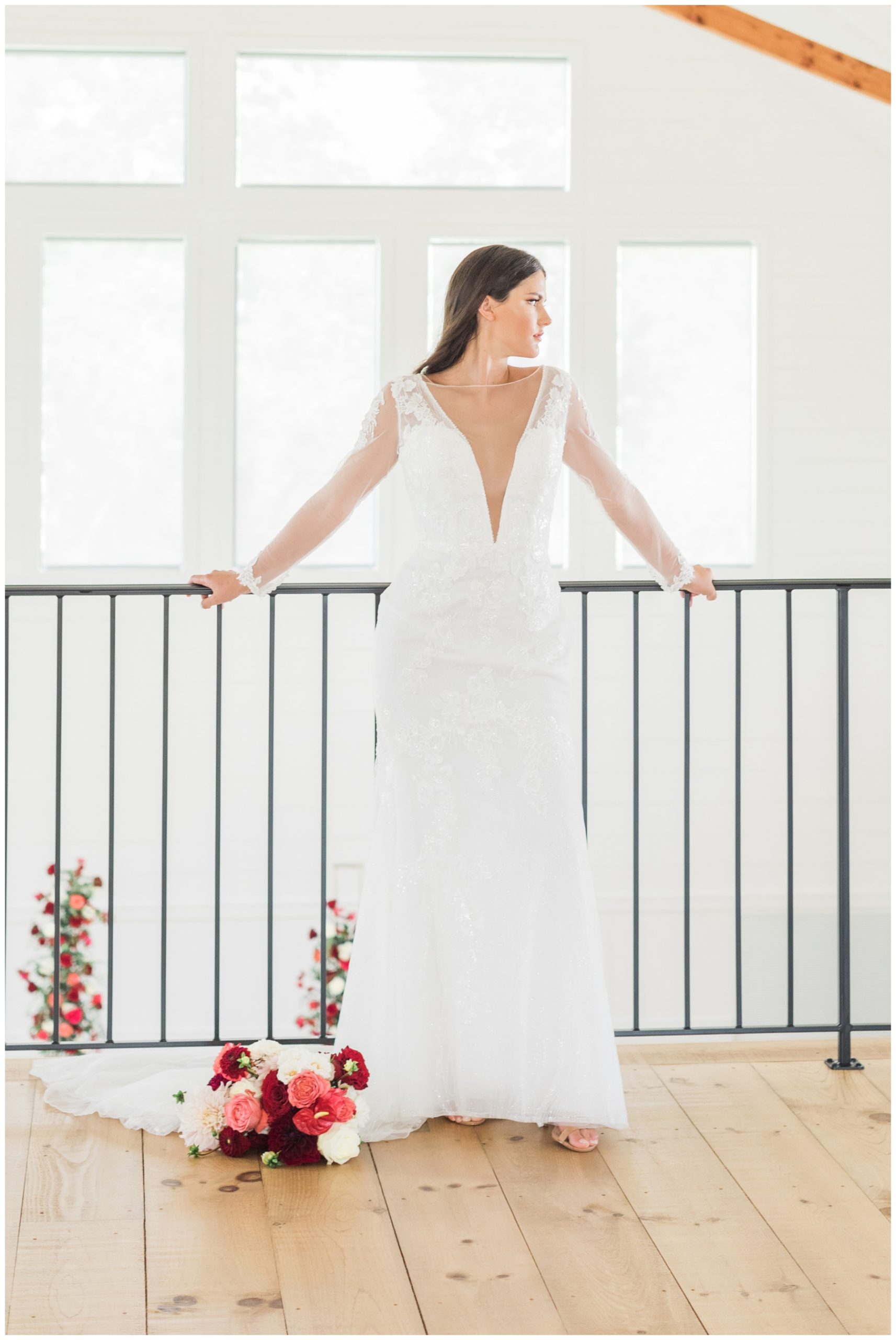 Bride in a long sleeved wedding gown with deep v neckline