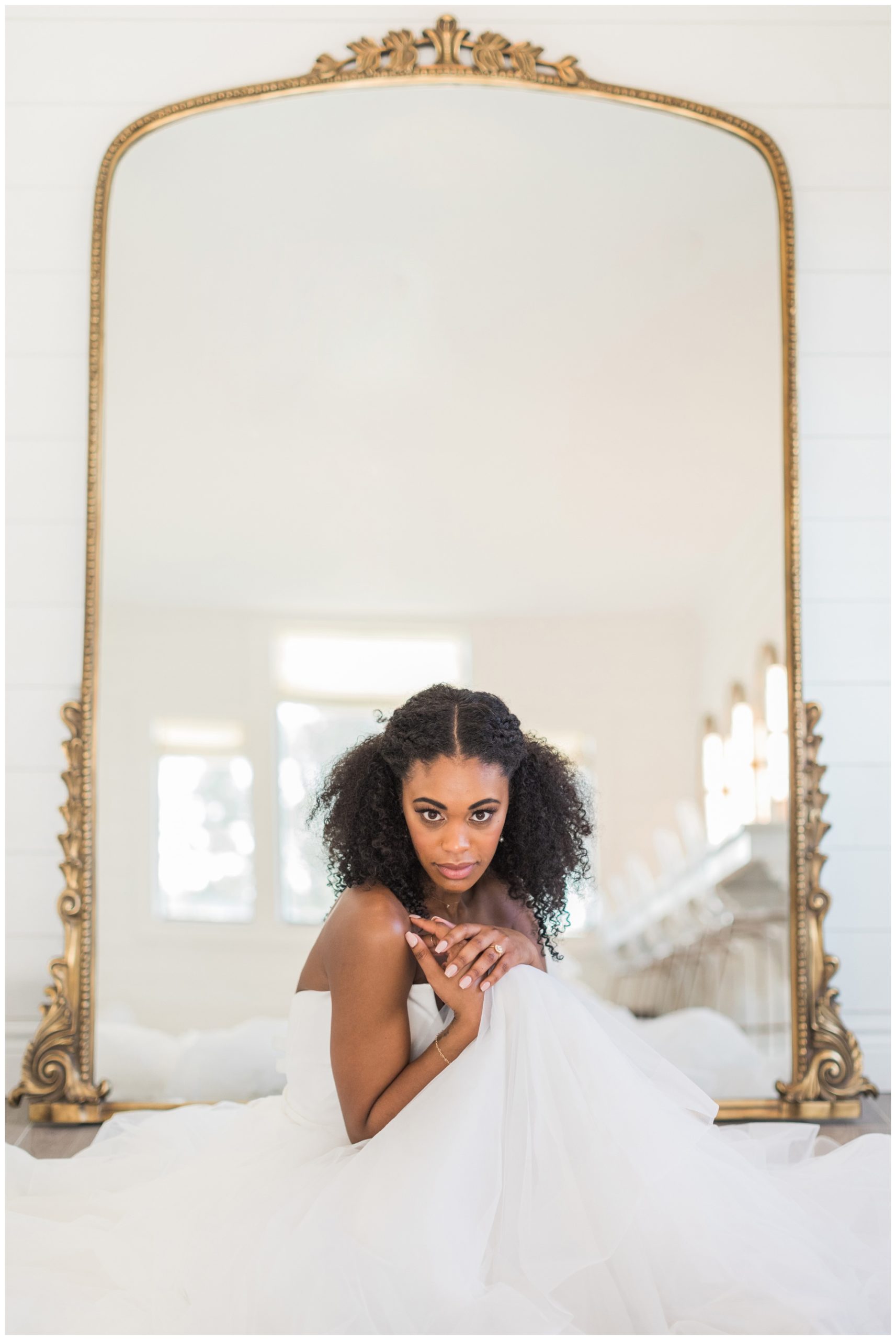 Bride posing in front of a gold floor mirror for her bridal session at Boxwood Manor