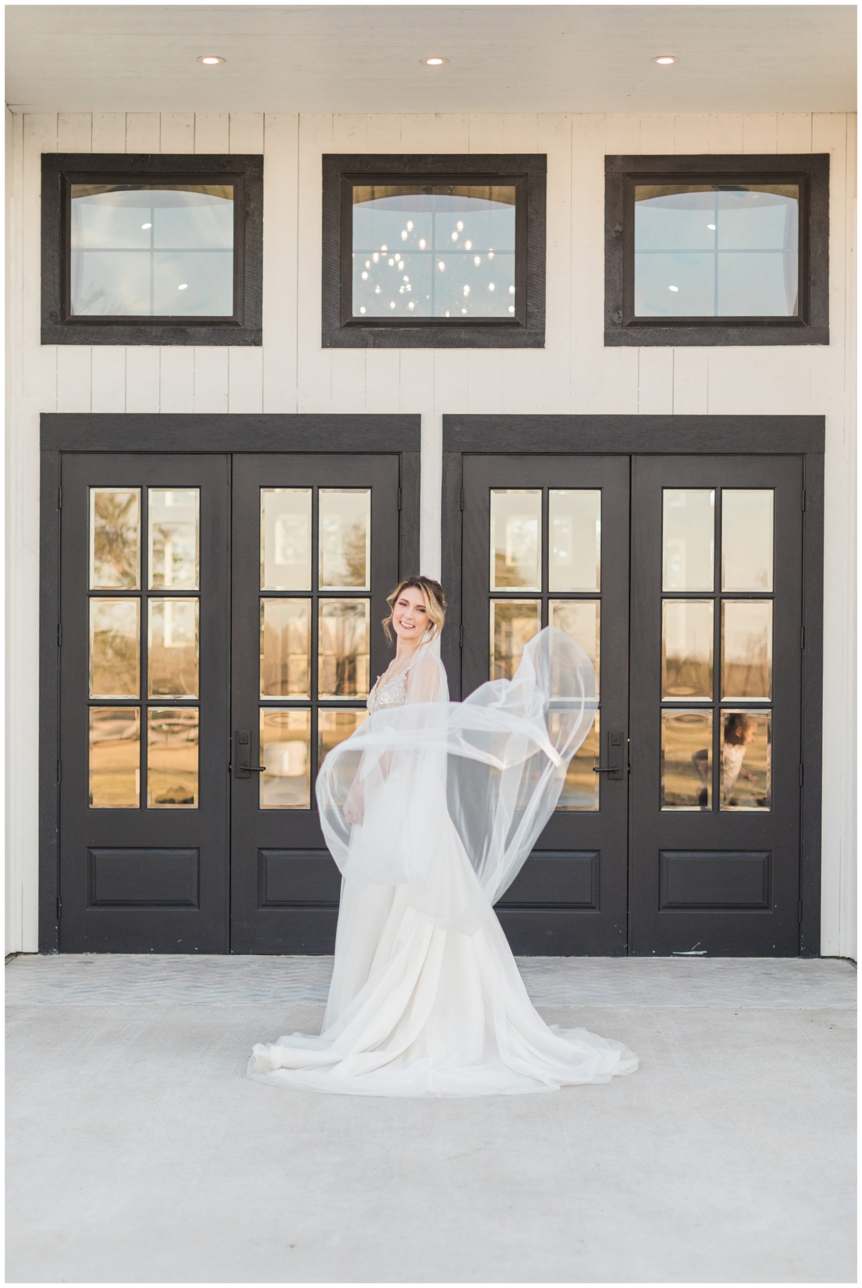 Bride posing with her veil for her bridal session