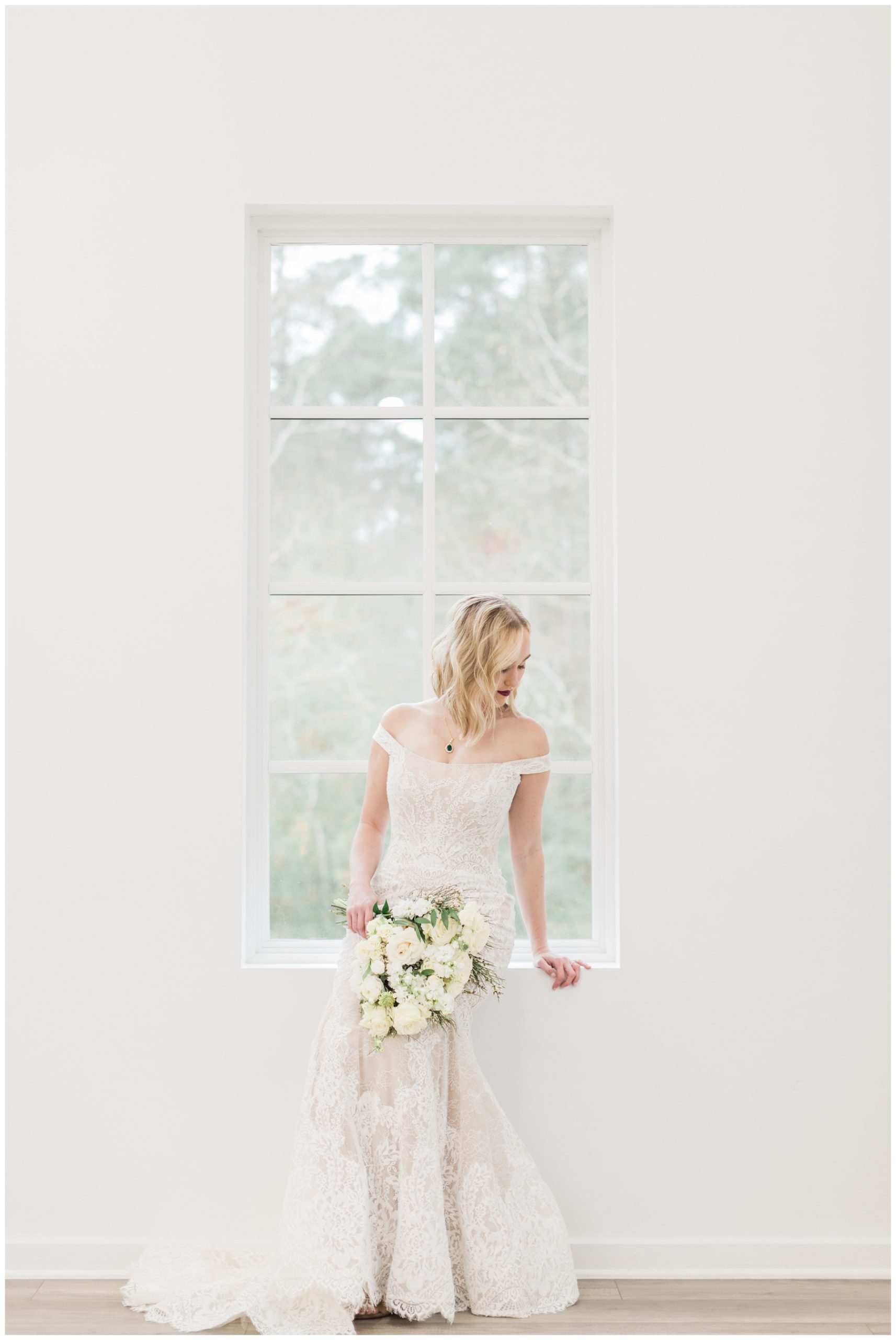 Bride in an off-the-shoulder lace gown for her bridal session at Addison Woods