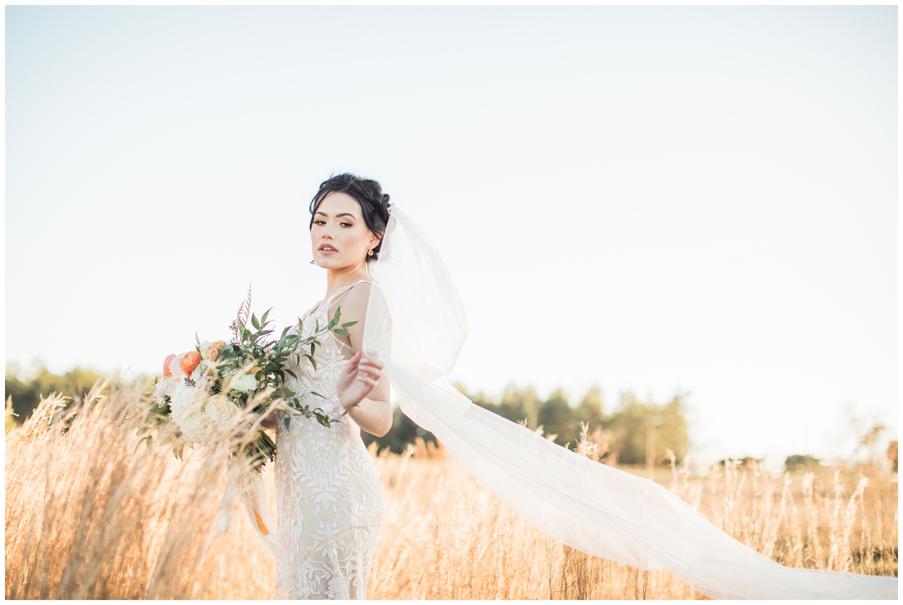 Bride in a sleeveless lace wedding gown with floral motifs by BHLDN