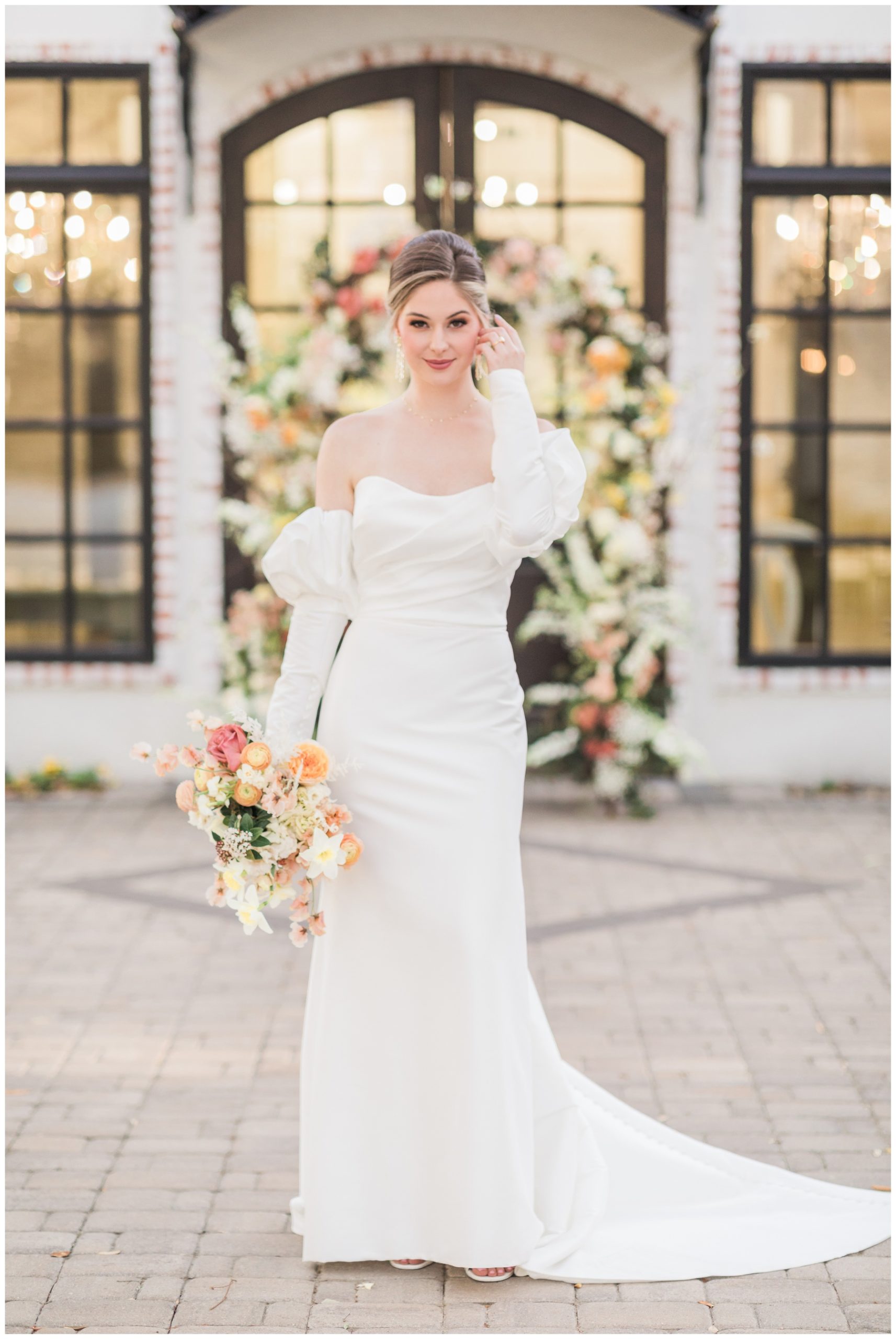 Bride in a satin off-the-shoulder puff sleeve bridal gown from Brickhouse Bridal