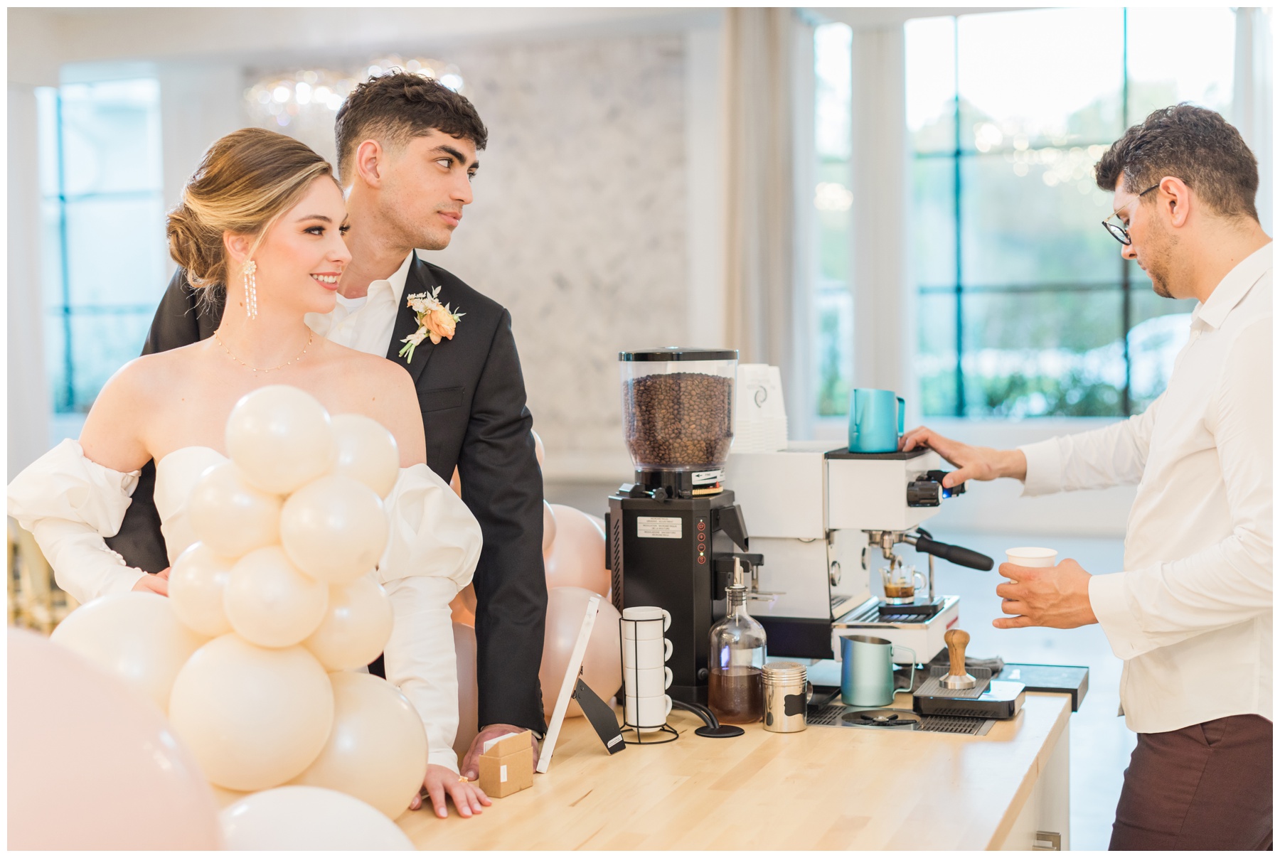 Brightside Coffee Cart decorated with blush and champagne balloons from Sugar Plum Event Co. for a wedding reception