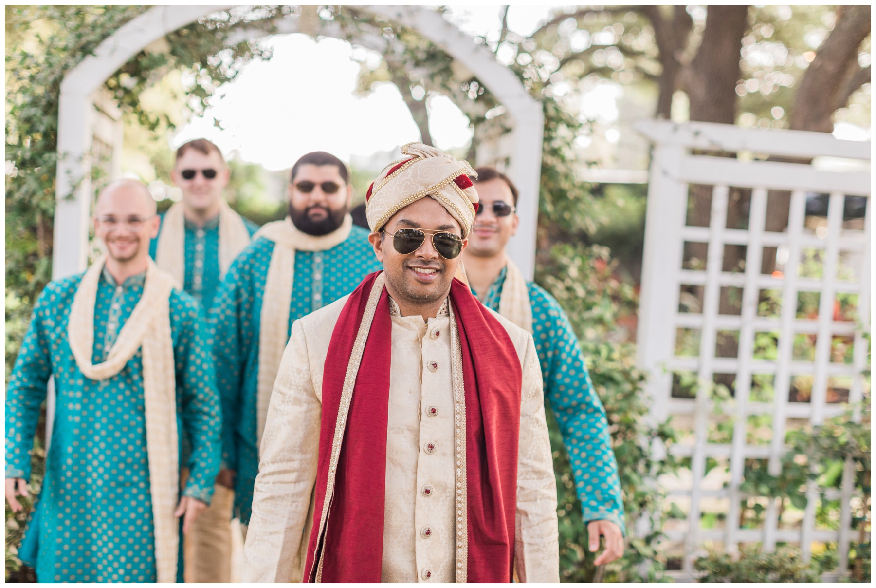 Groom wearing a gold sherwani and a red dupatta from Maharani Fashions