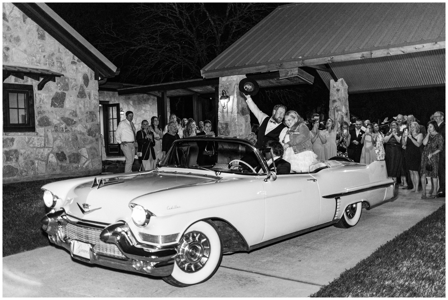 Bride and groom in a vintage getaway car