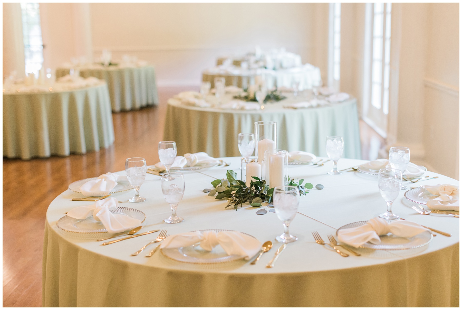 Sage linens and gold tableware at a wedding reception