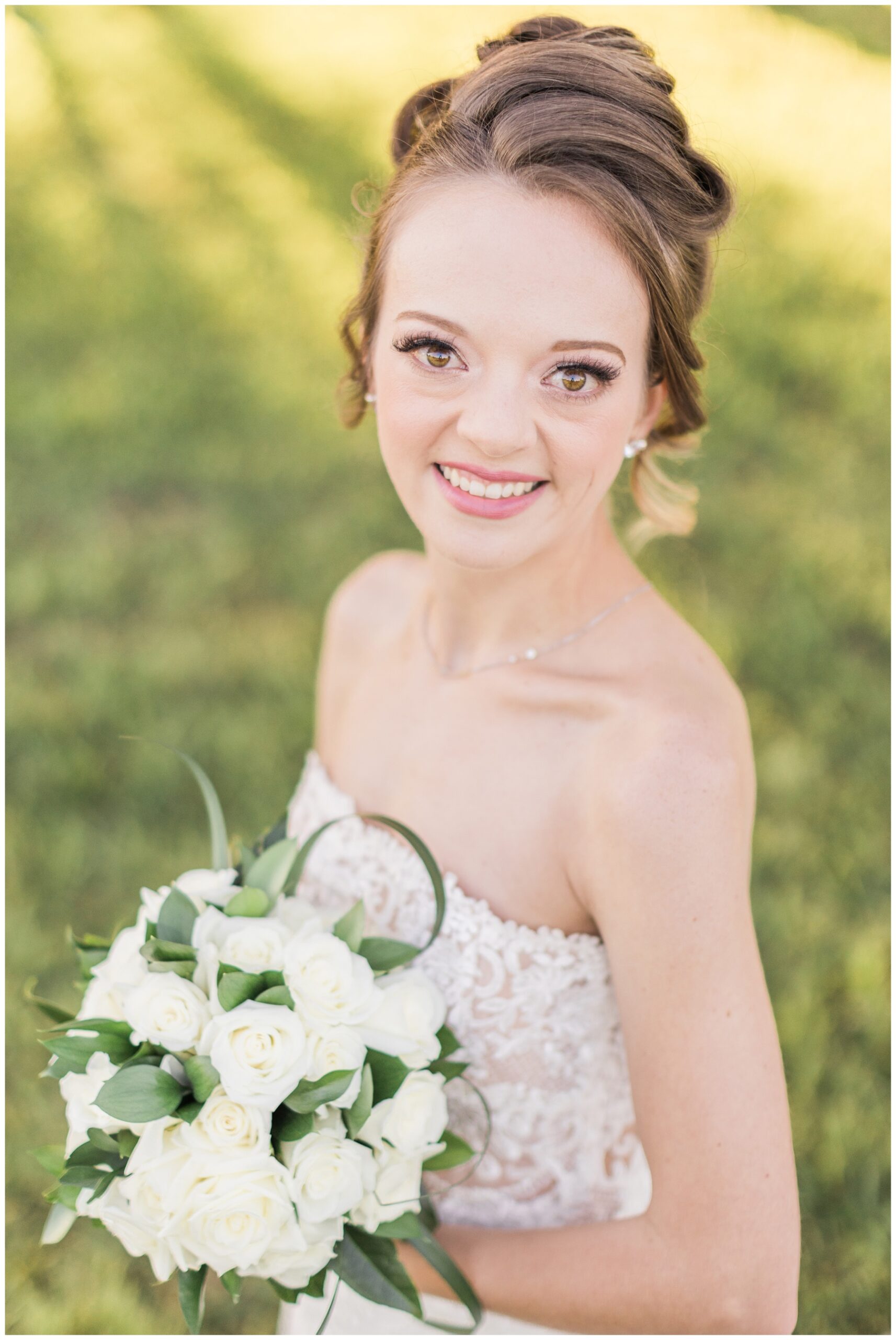 Bride holding a bouquet of white roses for her bridal session at WIllowynn Barn