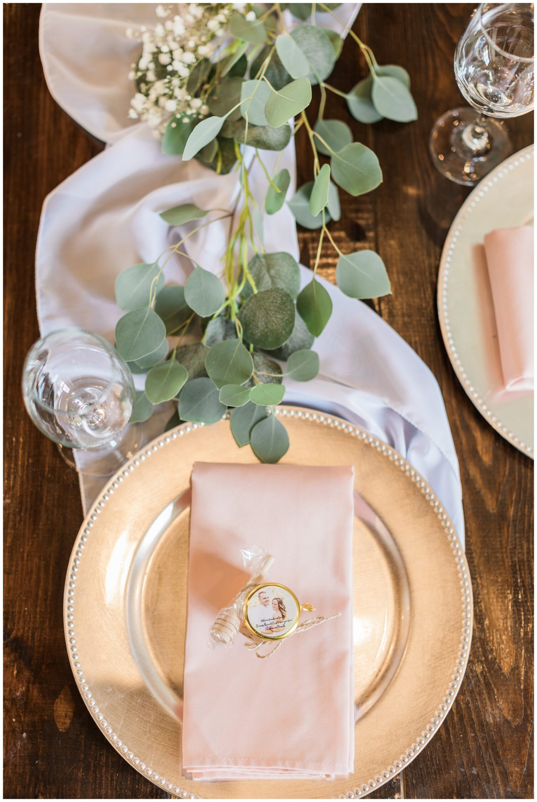 Classic wedding table setting with a copper plate and blush linen napkin