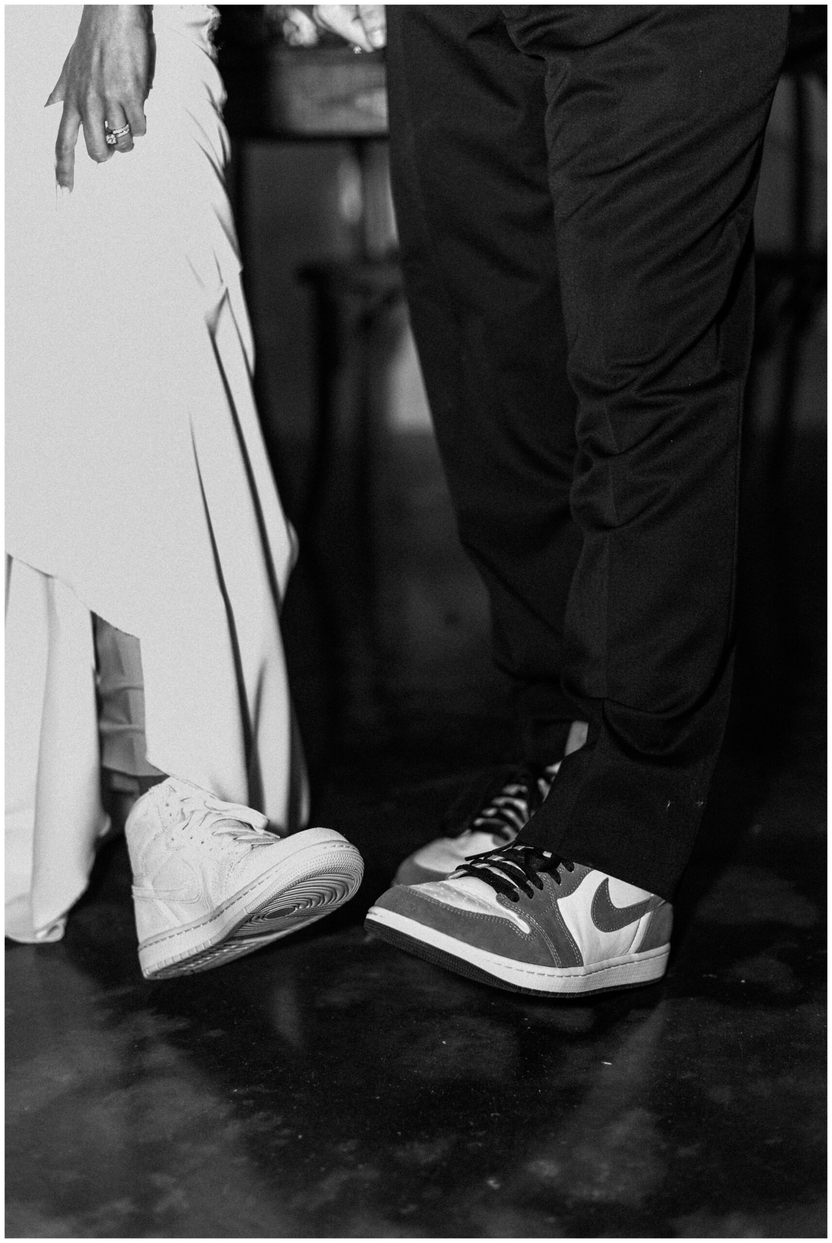 Bride and groom wearing matching Jordans at their wedding reception